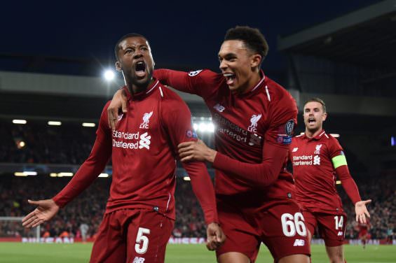 Liverpool's Dutch midfielder Georginio Wijnaldum (L) celebrates with Liverpool's English defender Trent Alexander-Arnold (C) and Liverpool's English midfielder Jordan Henderson after scoring their third goal during the UEFA Champions league semi-final second leg football match between Liverpool and Barcelona at Anfield in Liverpool, north west England on May 7, 2019. (Photo by Paul ELLIS / AFP)