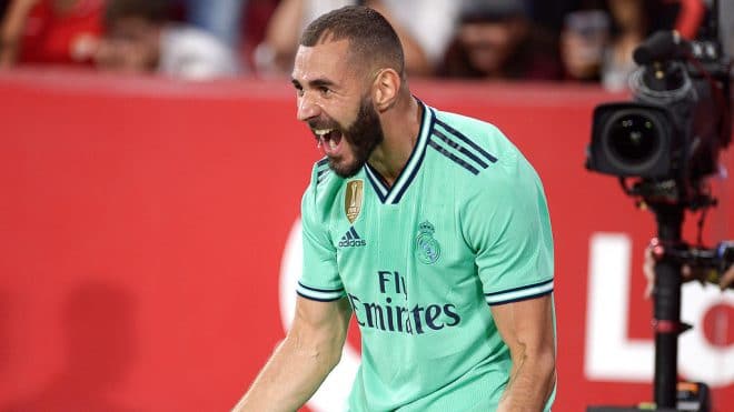 Real Madrid's French forward Karim Benzema celebrates after scoring a goal during the Spanish league football match between Sevilla FC and Real Madrid CF at the Ramon Sanchez Pizjuan stadium in Seville on September 22, 2019. (Photo by CRISTINA QUICLER / AFP)