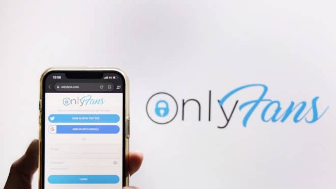 BANGKOK,THAILAND-JUNE 29: View of The Hand Holding a Mobilephone with Onlyfans Logo on the Screen Against Onlyfans Logo Background on June 29,2021