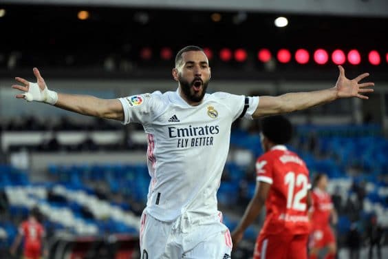 (FILES) In this file photo taken on May 9, 2021 Real Madrid's French forward Karim Benzema celebrates after scoring an eventually disallowed goal during the Spanish League football match between Real Madrid CF and Sevilla FC at the Alfredo di Stefano stadium in Valdebebas, on the outskirts of Madrid. - Deschamps calls Benzema back into the national team for the upcoming Euro, AFP reports on May 18, 2021. (Photo by PIERRE-PHILIPPE MARCOU / AFP)