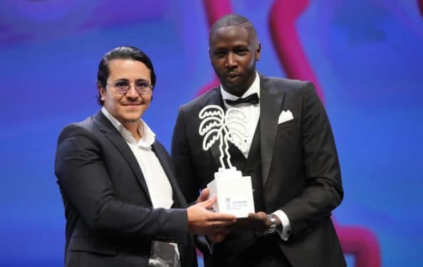 French actors Brahim Bouhlel (L) and Saidou Camara pose with the trophy for Audience Award for the Best Serie for "Valide" during the closing ceremony of the 3rd edition of the Cannes International Series Festival (Canneseries) in Cannes, southern France on October 14, 2020. (Photo by Valery HACHE / AFP)