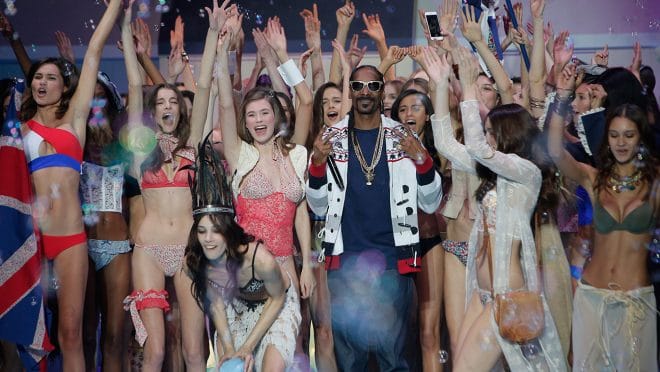 U.S Rapper Snoop Dogg poses with models at the end of Etam's ready-to-wear fall-winter 2015/2016 fashion collection presented in Paris, France, Tuesday, March 3, 2015. (AP Photo/Thibault Camus)