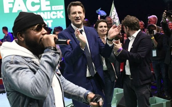 French ecologist party Europe Ecologie-Les Verts's (EELV) presidential candidate Yannick Jadot (C) dances as French rap band Arsenik performs at the start of a campaign meeting ahead of the French presidential election first round on April 10, 2022. (Photo by STEPHANE DE SAKUTIN / AFP)