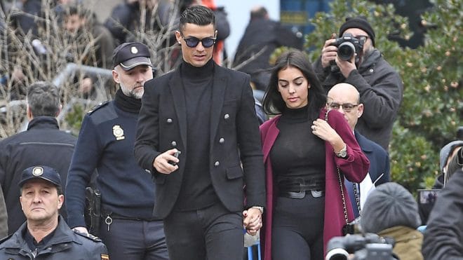 Juventus' forward and former Real Madrid player Cristiano Ronaldo leaves with his Spanish girlfriend Georgina Rodriguez after attending a court hearing for tax evasion in Madrid on January 22, 2019. - Ronaldo is expected to be given a hefty fine after Spanish tax authorities and the player's advisors made a deal to settle claims he hid income generated from image rights when he played for Real Madrid. (Photo by PIERRE-PHILIPPE MARCOU / AFP)        (Photo credit should read PIERRE-PHILIPPE MARCOU/AFP via Getty Images)