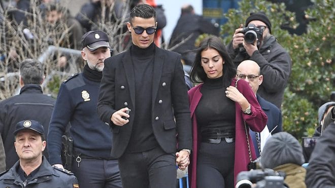 Juventus' forward and former Real Madrid player Cristiano Ronaldo leaves with his Spanish girlfriend Georgina Rodriguez after attending a court hearing for tax evasion in Madrid on January 22, 2019. - Ronaldo is expected to be given a hefty fine after Spanish tax authorities and the player's advisors made a deal to settle claims he hid income generated from image rights when he played for Real Madrid. (Photo by PIERRE-PHILIPPE MARCOU / AFP) (Photo credit should read PIERRE-PHILIPPE MARCOU/AFP via Getty Images)