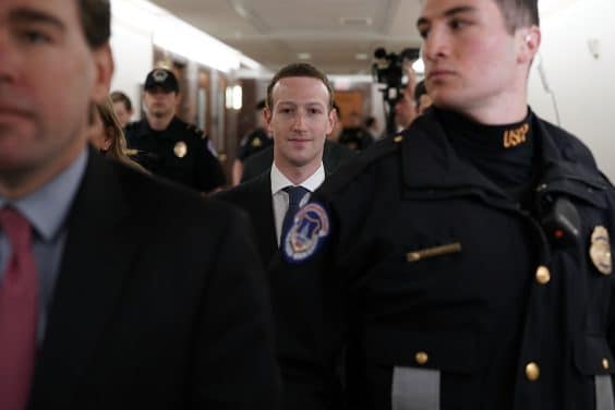 WASHINGTON, DC - APRIL 09:  Facebook CEO Mark Zuckerberg (C) is escorted by U.S. Capitol Police as he walks in a hallway prior to a meeting with U.S. Sen. John Thune (R-SD), committee chairman of Senate Committee on Commerce, Science, and Transportation, April 9, 2018 on Capitol Hill in Washington, DC. Zuckerberg is scheduled to testify before a few Congressional committees this week on the mass users data Facebook has shared with political operatives.  (Photo by Alex Wong/Getty Images)